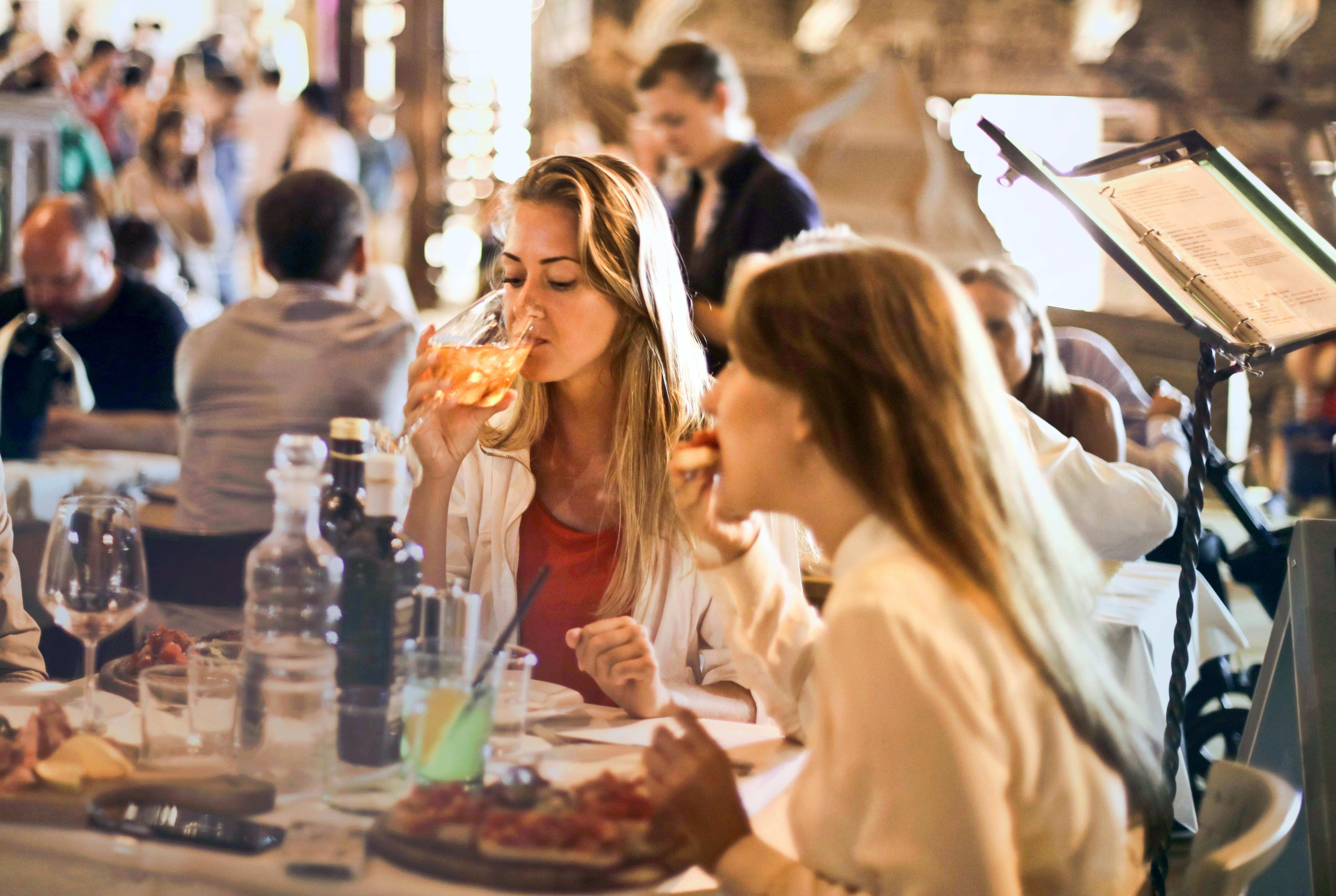 Woman eating at restaurant near sunrise beach, mo