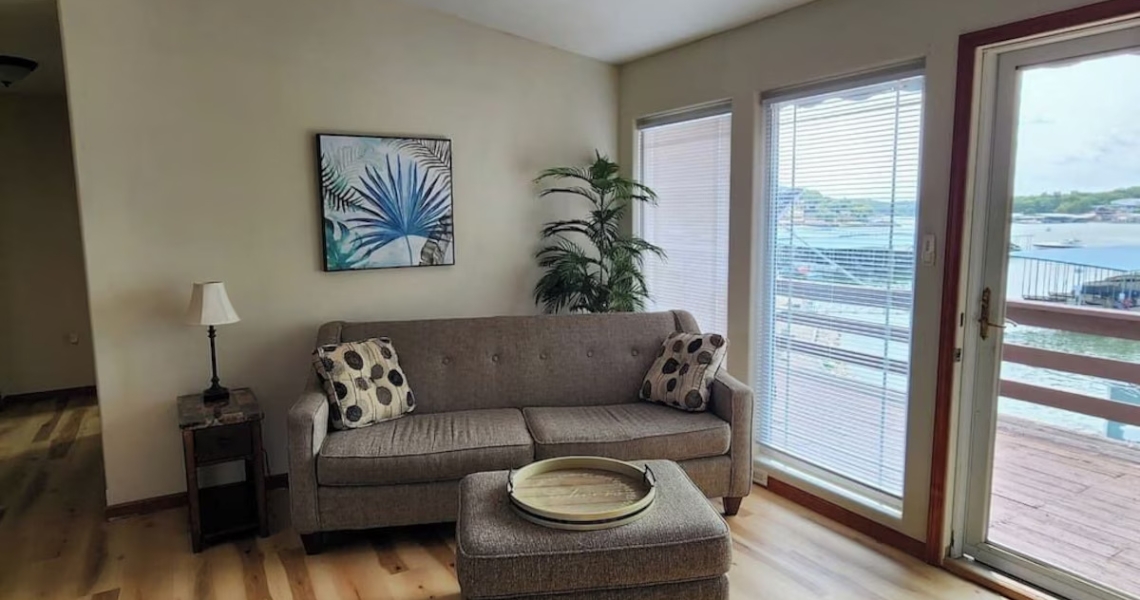 couch inside living room of boat house rental at lake of the ozarks